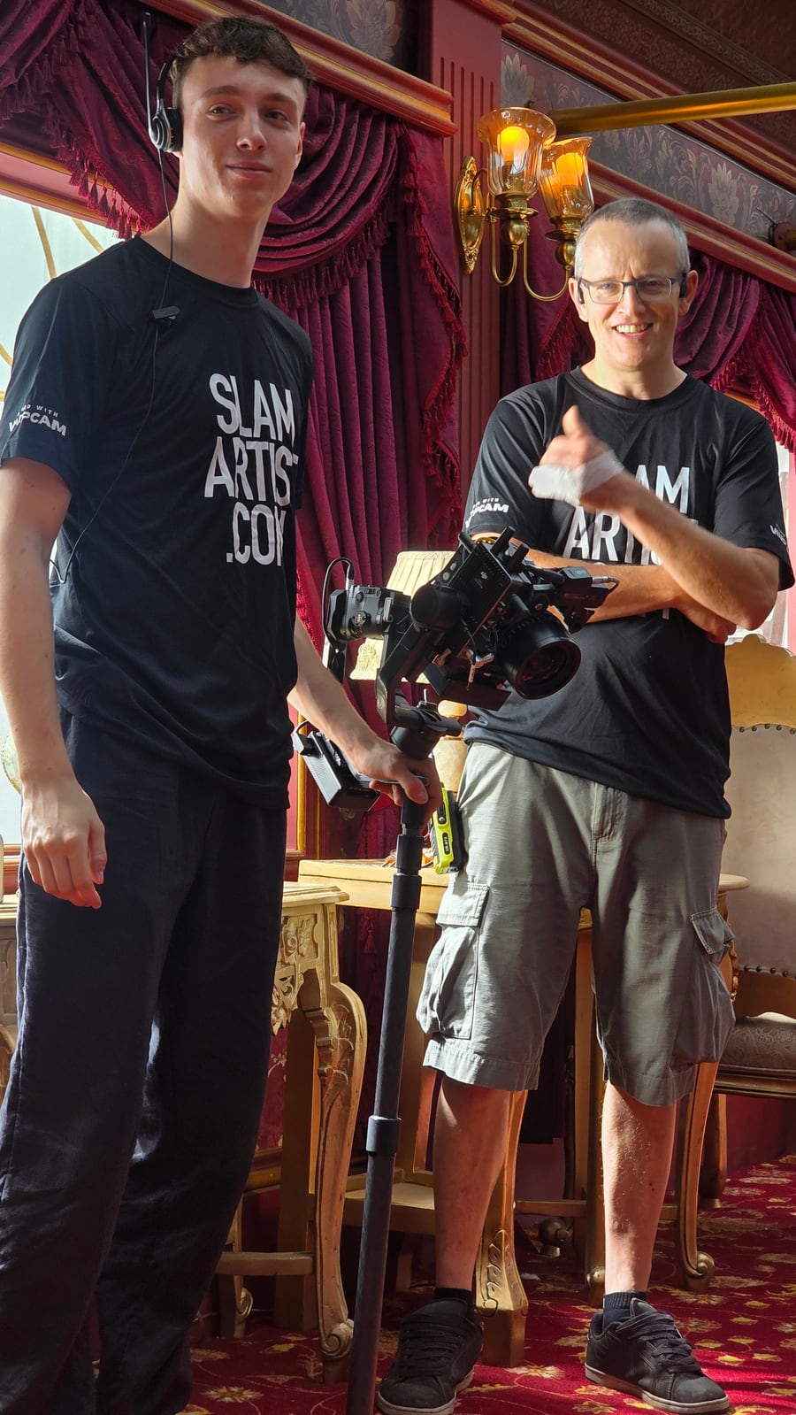 Two crew members with the Hyper-WarpCam® Ember camera and pole-mounted gimbal on an interior set.