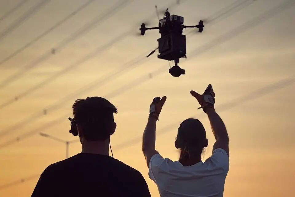 Crew launches an FPV camera rig during action production on Jawan